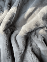 Experience luxury redefined with ONE Preevay's Faux Rabbit Fur Throw in Dramatic Gray. Inspired by Fernando Botero, crafted from Ultra Premium Faux Rabbit Fur. Hypoallergenic, cruelty-free, and lined with elegant velvet for refined warmth and sophistication. 800gsm, 50x60 inches