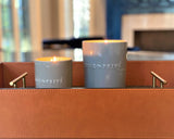 Indulge in the French Black Orchid Perfumed Estate Candle from One Preevay. Handcrafted with premium essential oils and organic soy wax, it features a pale gray ceramic vessel. With a triple wick and 21.2 oz size, enjoy the aromatic blend of blackberry, patchouli, and spices. Elevate your ambiance today.