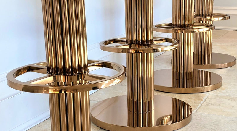 Discover the Atlas Bar Stool by One Preevay, inspired by the Chrysler Building. Customizable with textured bronze metal and plush velvet. Perfect for luxury residences and upscale spaces close up base close up 