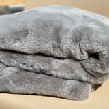 Experience luxury redefined with ONE Preevay's Faux Rabbit Fur Throw in Dramatic Gray. Inspired by Fernando Botero, crafted from Ultra Premium Faux Rabbit Fur. Hypoallergenic, cruelty-free, and lined with elegant velvet for refined warmth