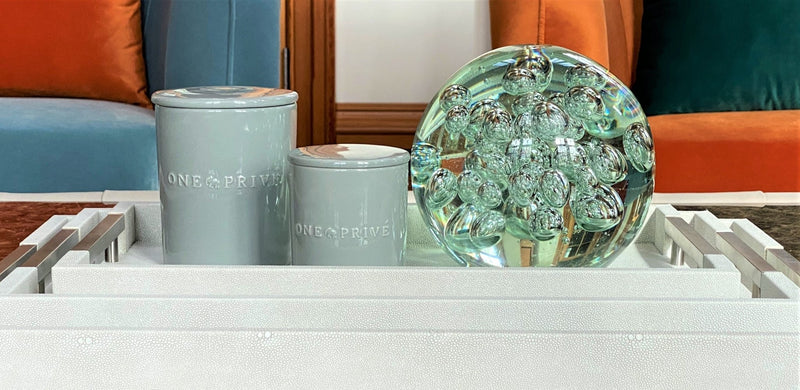 Discover the Moroccan Amber Perfumed Estate Candle from One Preevay. Handcrafted with essential oils and soy wax, this 21.2 oz candle features a triple wick and pale gray porcelain vessel with Thursby Tray 