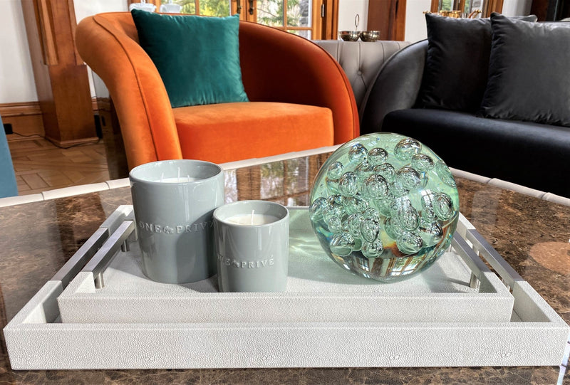 Discover the Moroccan Amber Perfumed Estate Candle from One Preevay. Handcrafted with essential oils and soy wax, this 21.2 oz candle features a triple wick and pale gray porcelain vessel with Two Thursby Trays