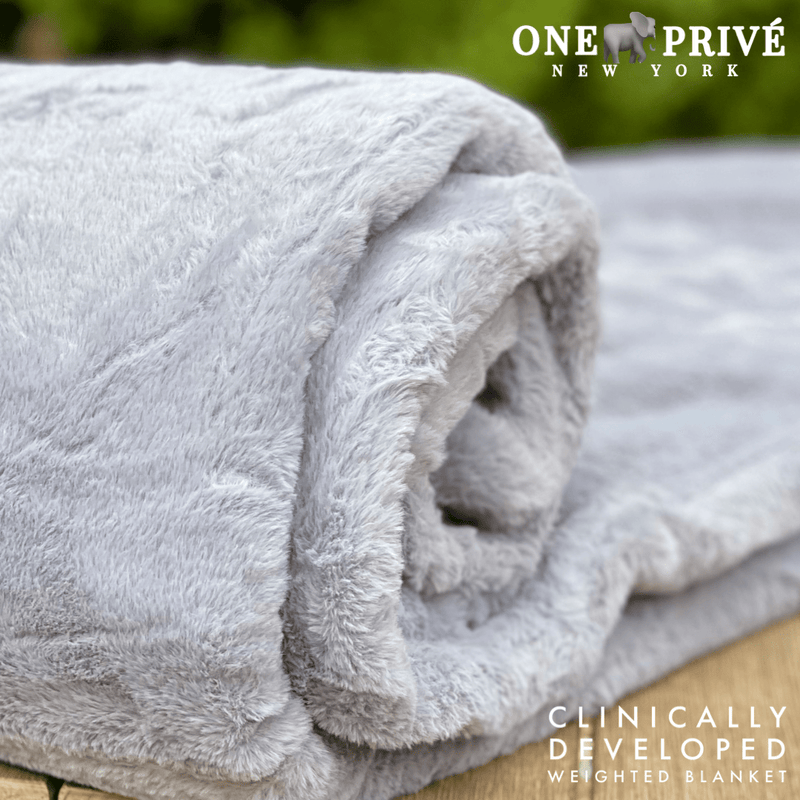 Experience luxurious relaxation with One Preevay's world's first weighted faux rabbit fur blanket, inspired by Fernando Botero. Clinically developed, 20lbs, hypoallergenic, and luxurious for serene sleep & relaxation.