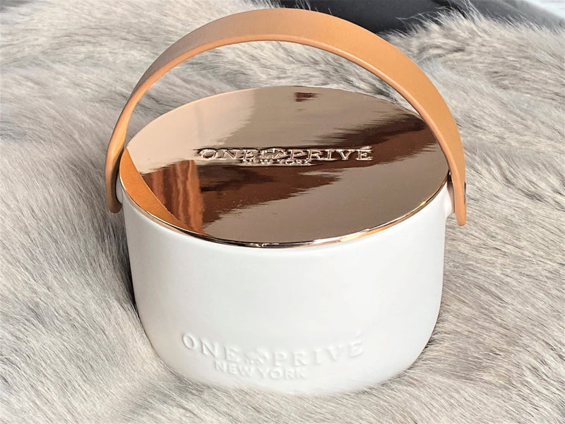 Indulge in the Bergamot and Clove Perfumed Estate Candle from One Preevay. Handcrafted with premium essential oils and soy wax, it features a stunning porcelain bowl with a silver-plated lid and leather strap. Elevate your ambiance with sophistication and style. Order now.
